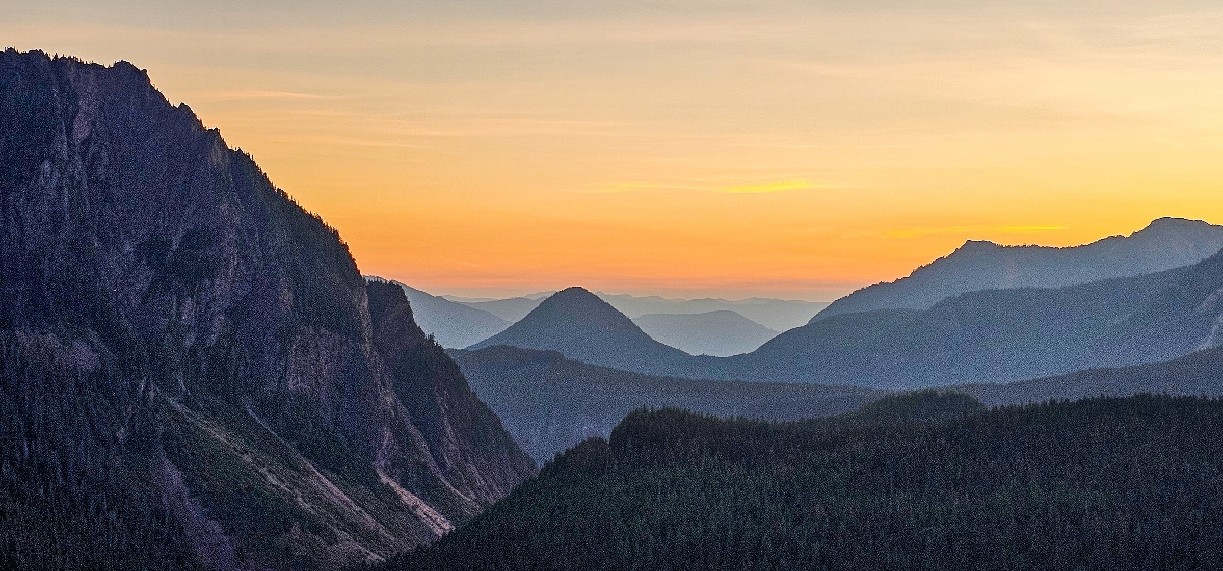 Mountain ridges beneath a golden sky in Washington State, photographed by Martha Solo