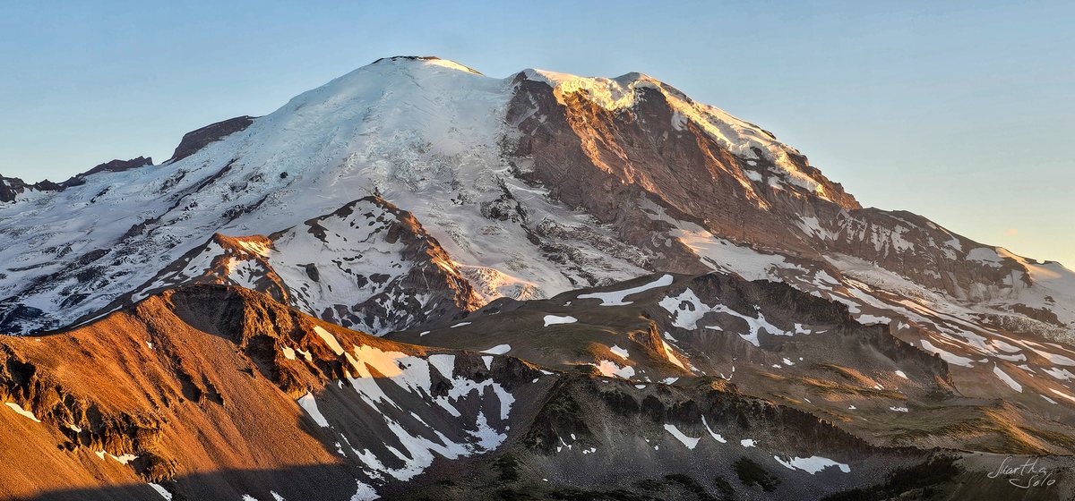 Snow-covered Mount Rainier in golden evening light β nature photograph by Martha Solo